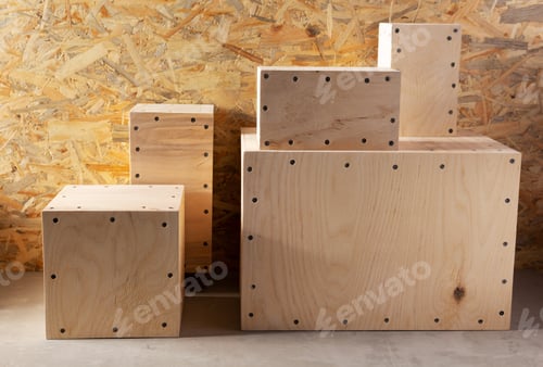 Preview: Stack of wooden cube or plywood box block near wall background texture. Construction concept