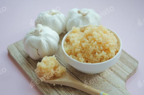 Preview: close up of minced garlic on a wooden spoon
