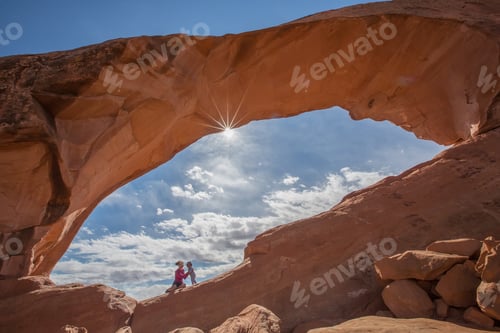 Preview: Mother With Her Baby Son Stay Below Skyline Arch In Arches National Park In Utah, Usa
