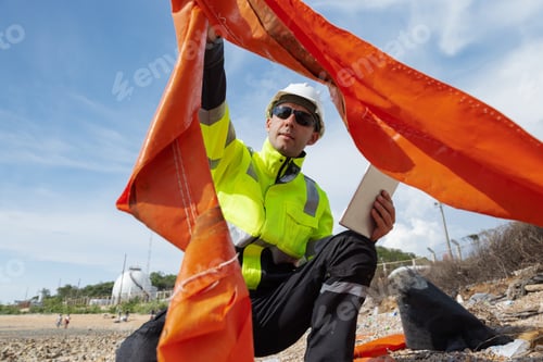Preview: Environmental engineers inspect coastal waste and record data