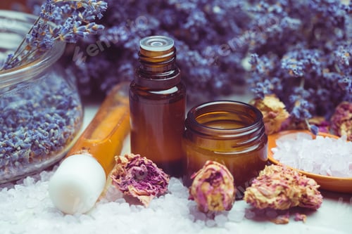 Preview: Lavender and rose essence bottles with dried flowers and crystals on wooden surface