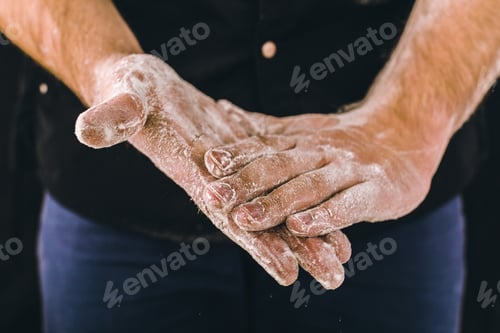 Preview: adult man hands work with flour, dark photo