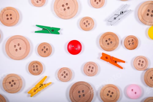 Preview: Buttons And The Pins Lying On A White Background