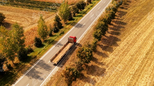 Preview: Truck on the road through countryside, aerial view