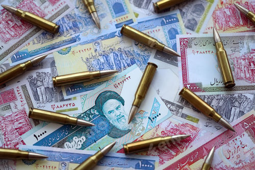 Preview: Many bullets and iranian rials money bills close up. Concept of terrorism