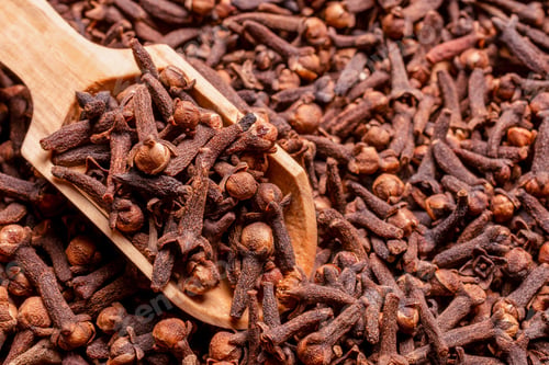 Preview: Closeup of a spoon and cloves on a solid ground surface