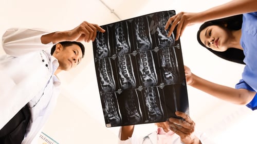 Preview: Doctor and medical assistants discussing about diagnosis result on x-ray film.