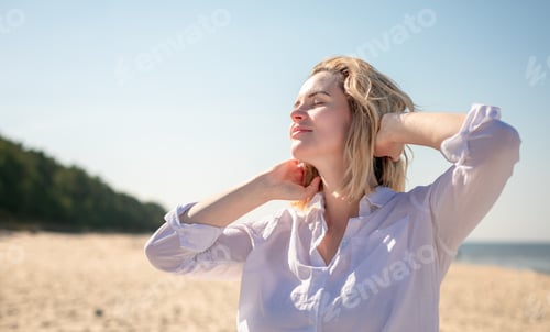 Preview: Portrait of natural young woman walking on sandy beach at sunny day