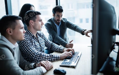 Preview: Software engineers working in office on project together