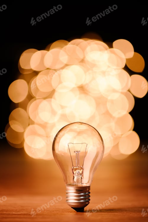 Preview: close up view of light bulb and bokeh lights on background