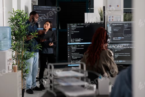 Preview: Two app developers analyzing html code looking for errors
