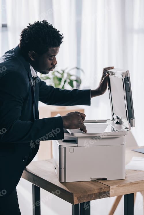 Preview: african american manager using copier at office