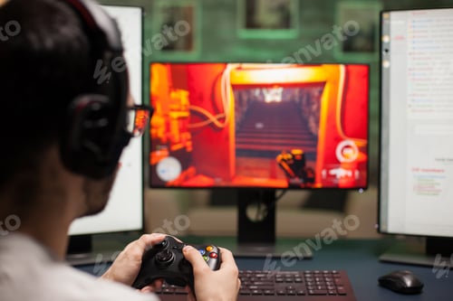 Close up of man using joystick while playing shooter games