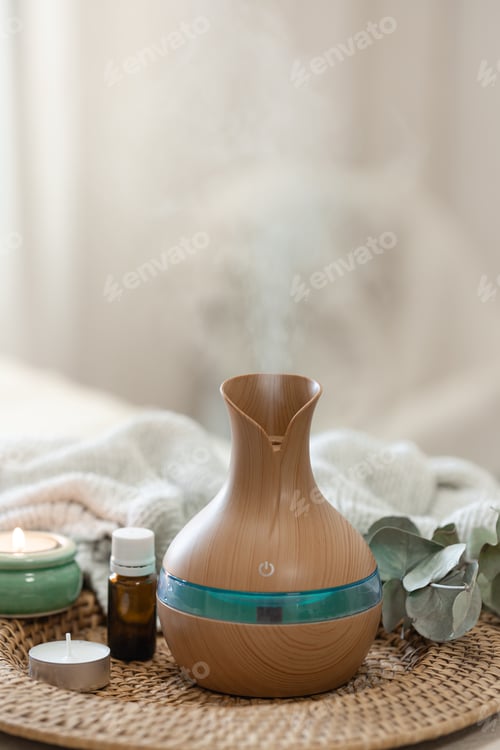 Preview: Spa composition with aroma oil diffuser lamp on a blurred background.