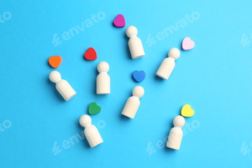 Preview: Tolerance concept. Human figures and colorful hearts on light blue background, flat lay