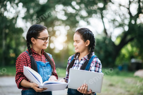 Preview: Two study girl talking to each other in park
