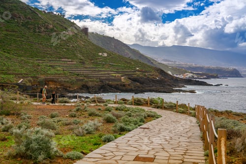 Preview: A picturesque coastal pathway in El Sauzal, Tenerife, with lush green hills and dramatic cliffs