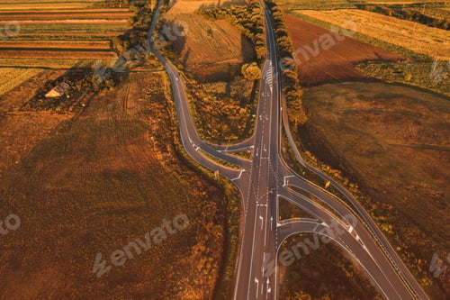 Preview: Vehicles on the road intersection through countryside landscape