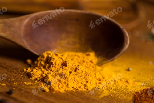 Preview: Spoon and heap of spices on the table
