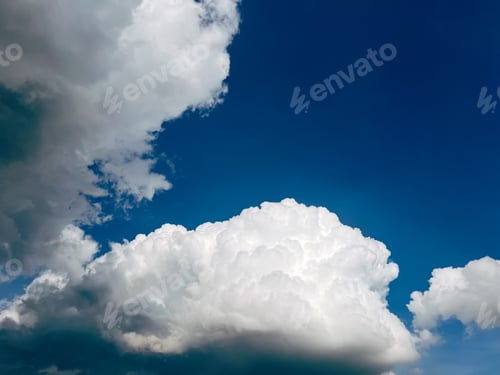 Preview: White puffy clouds on blue sky