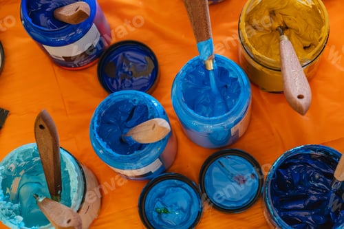 Preview: Paints brushes jars on the table