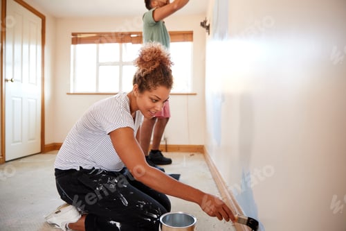 Preview: Couple Decorating Room In New Home Painting Wall Together