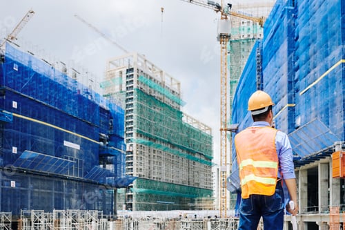 Preview: Professional engineer looking at building under construction