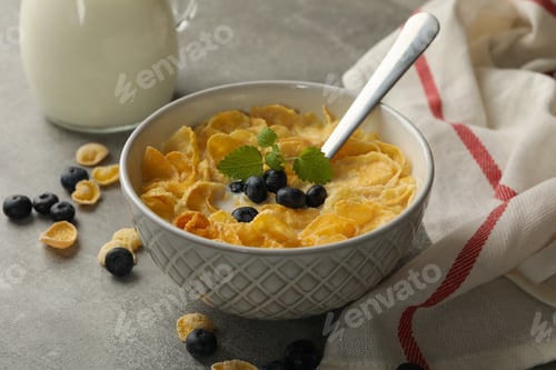 Preview: Concept of breakfast with muesli, milk and blueberry on gray table