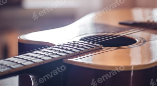Preview: Close-up, acoustic guitar on a blurred background.