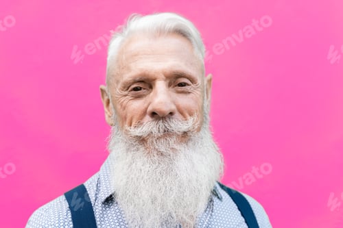 Preview: Portrait of happy hipster senior man smiling on camera - Focus in face