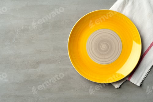 Preview: Top view of ceramic plate with table napkin on gray background