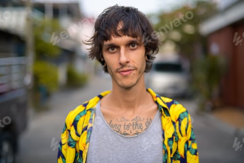 Preview: Face of young rebellious man in the streets outdoors
