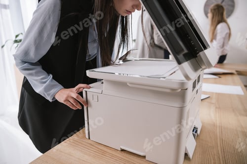 Preview: exhausted young businesswoman sleepy leaning on copier at conference room
