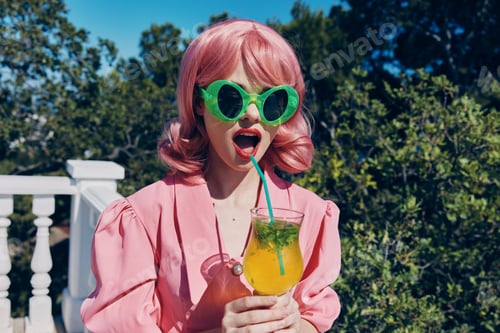Preview: Delighted young girl with pink hair summer cocktail refreshing drink Relaxation concept