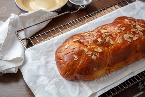 Preview: Fresh baked tsoureki braid. Easter sweet bread on the table, blur kitchen background