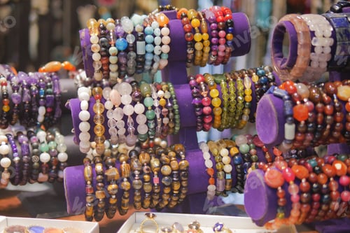 Preview: Bracelets with beads, laid out in the street market in the sun.