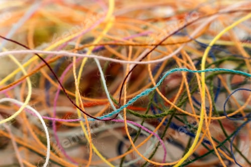 Preview: Multi-colored tangled colorful needlecraft silk thread rope. Macro shot. Abstract colors background