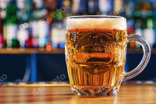 Preview: Fresh cold beer in glass on bar background