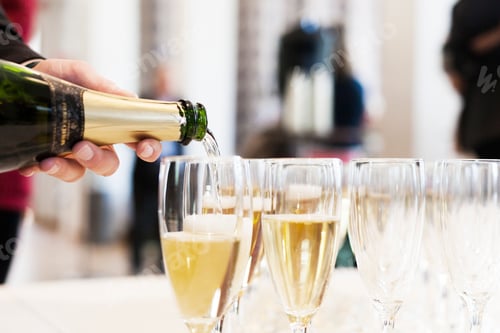 Preview: Pouring champagne into flutes for a celebration