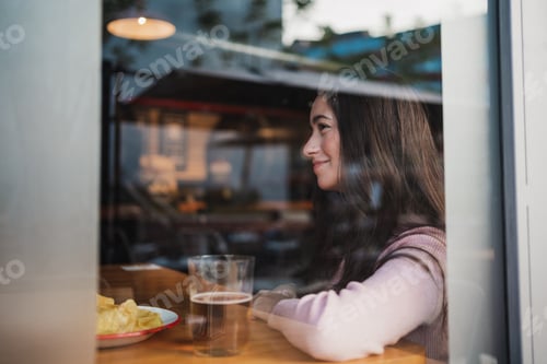 Preview: Happy young woman through a window