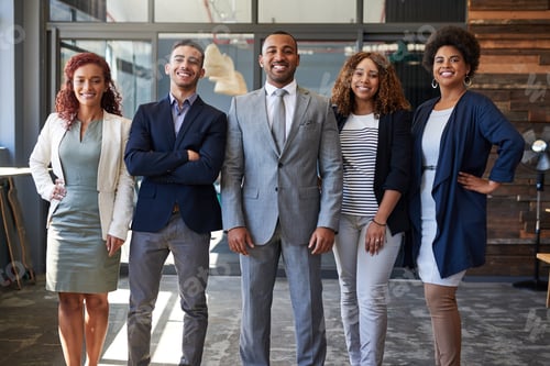 Preview: Portrait of a group of businesspeople standing together in an office