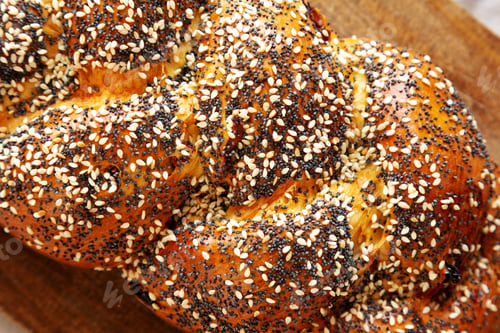 Preview: Homemade Challah Bread covered with Poppy and Sesame Seeds, top view.