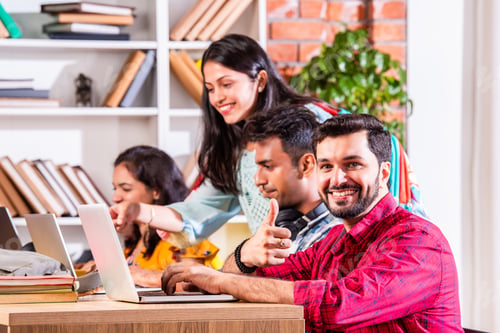 Preview: Indian asian four college or university students using laptop together