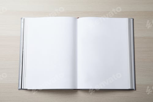 Preview: Open book with hard cover on wooden table, top view