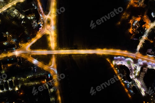 Preview: Aerial view of road intersection with fast moving heavy traffic at night. Top view of urban