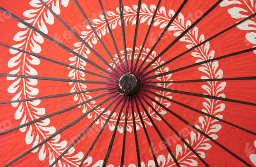 Preview: Red japanese umbrella with pattern isolated on white background. Symbol of protection.
