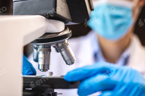 Preview: professional research scientist using microscope in science chemistry laboratory, medical technology