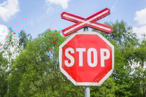 Preview: Stop and Railway crossing signs over blue sky background