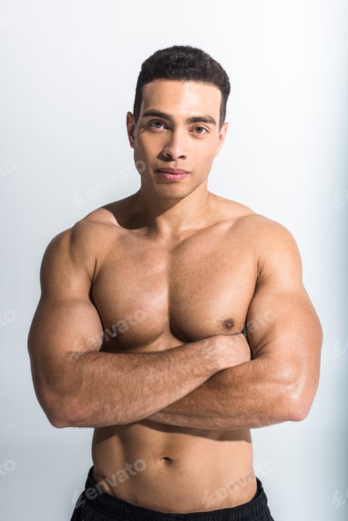 Preview: handsome sportive mixed race man posing with crossed arms on white