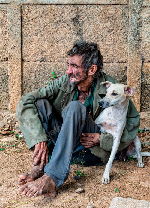 Preview: Vertical shot of a black homeless man sitting outdoors with a dog